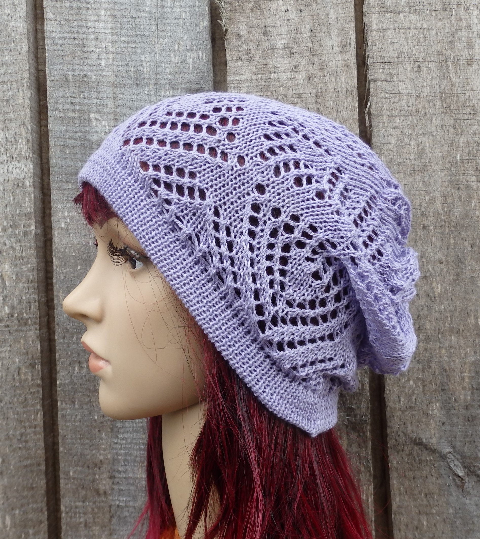 Lace knit purple headband on a mannequin against a wooden background