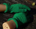 Green gardening gloves on a wooden surface