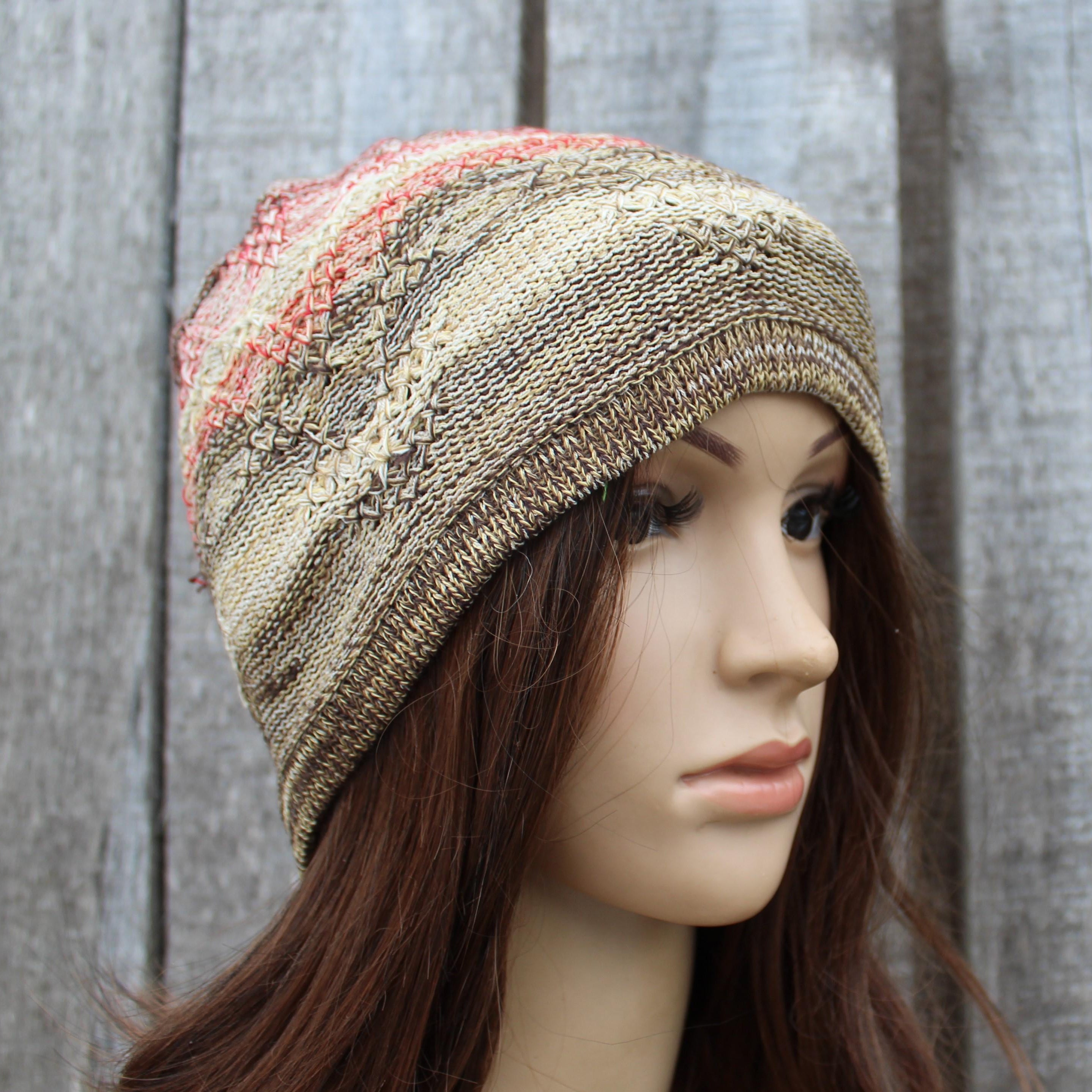 Knitted beanie on a mannequin head against a wooden background