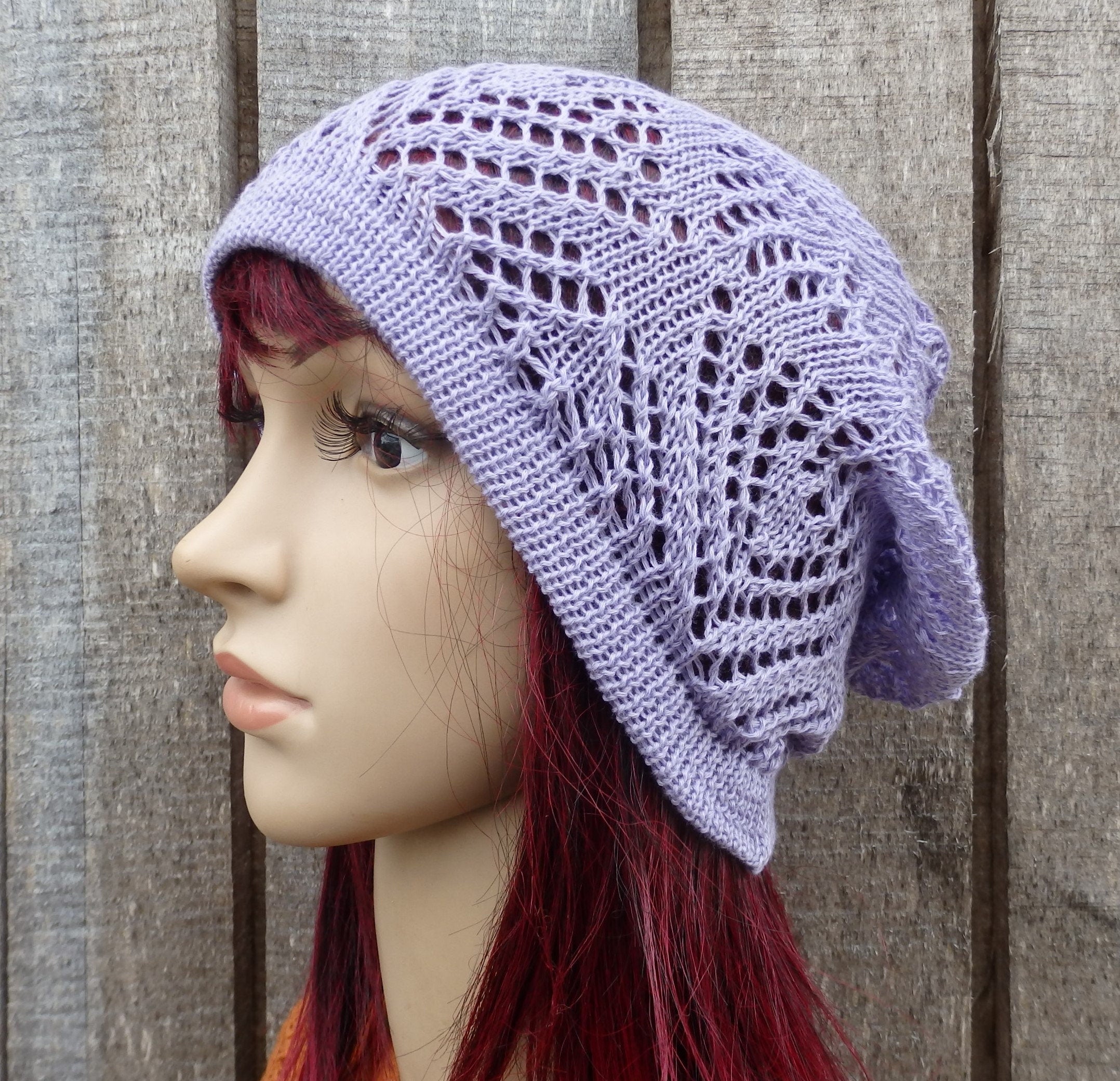 Lace purple headscarf on a mannequin against a wooden background