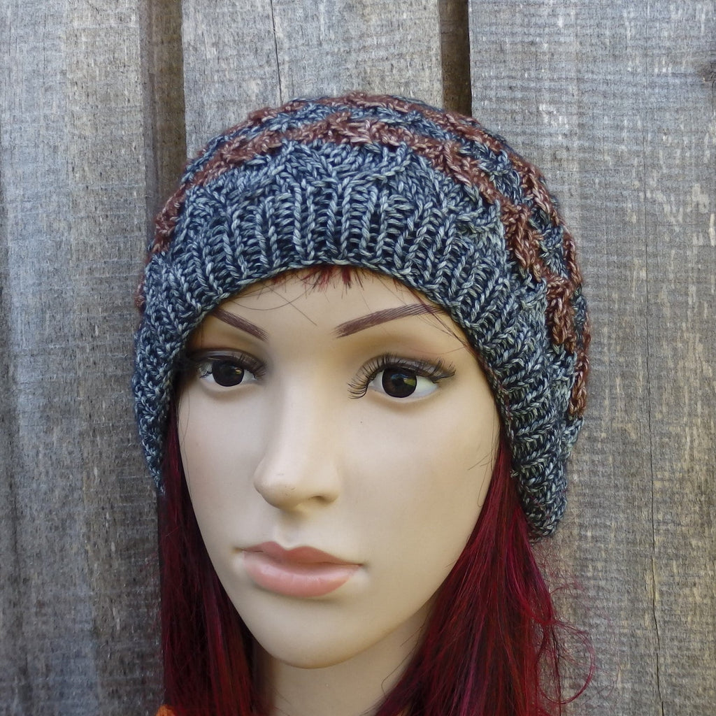 Knitted hat on a mannequin head against a wooden background