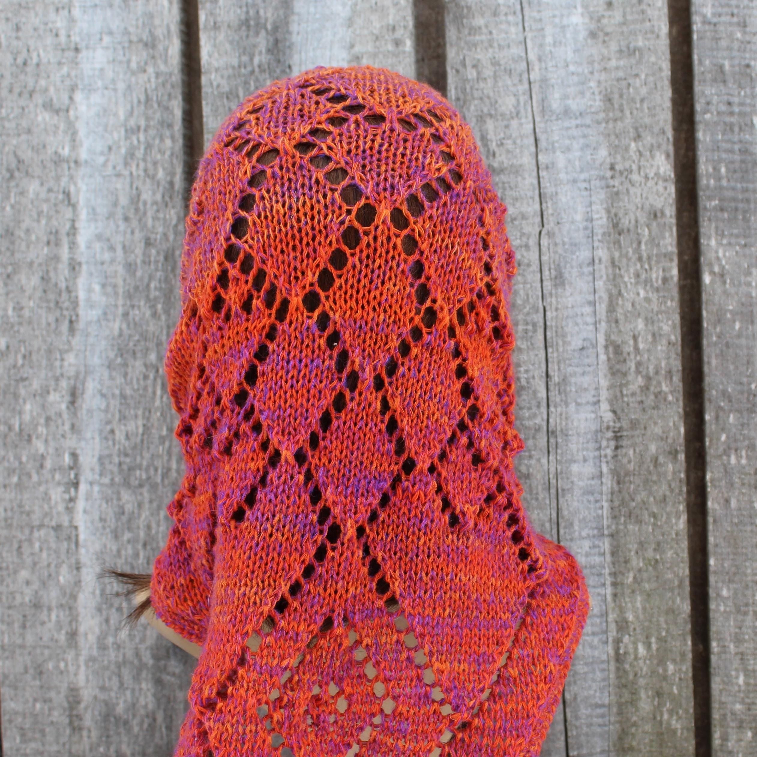Knitted head dress with a geometric pattern on a wooden background