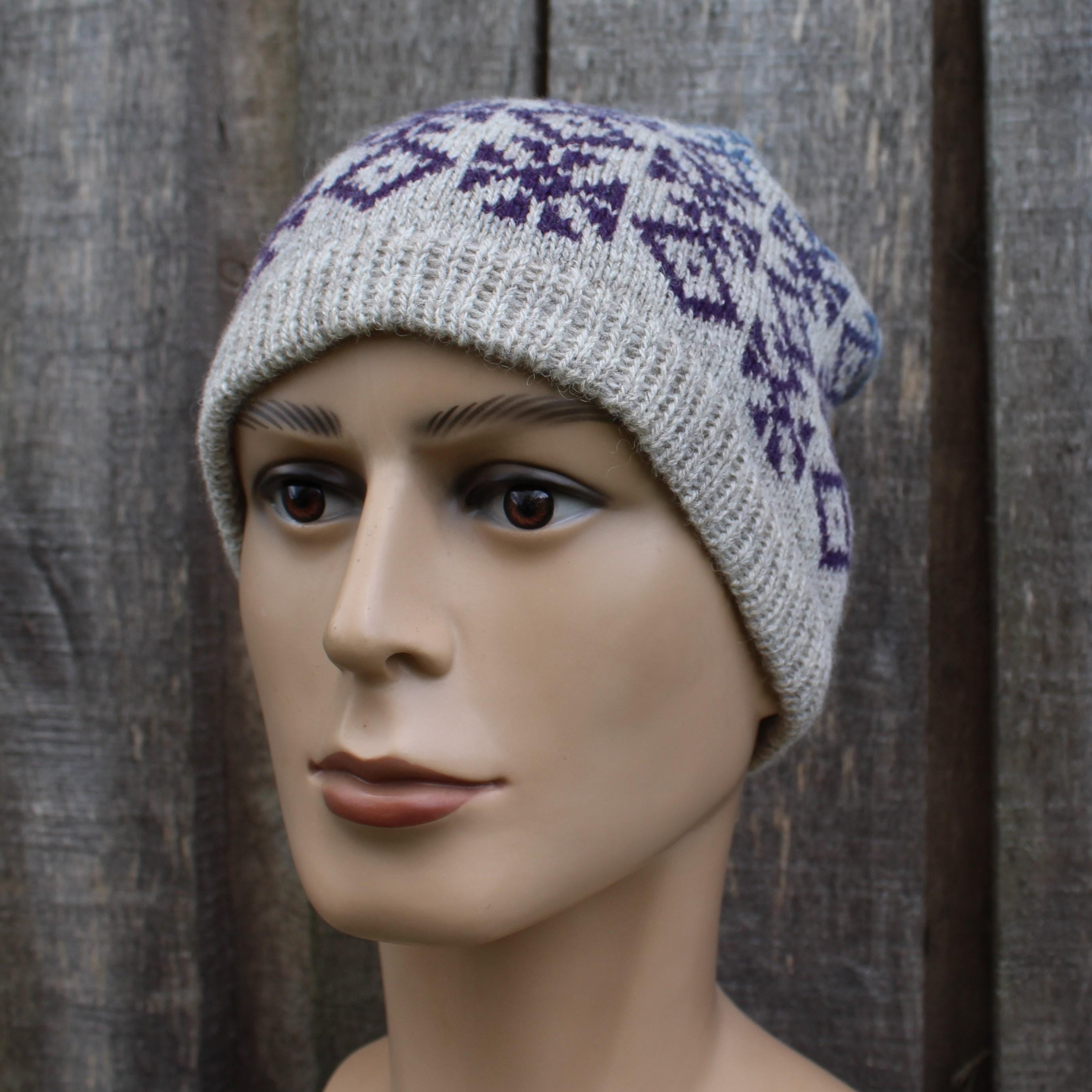 Knitted hat with a geometric pattern worn by a mannequin against a wooden background