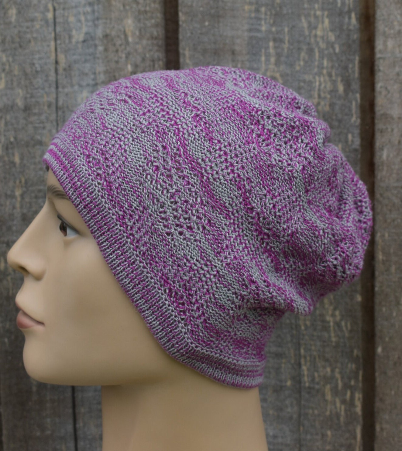 Knitted hat on a mannequin head against a wooden background