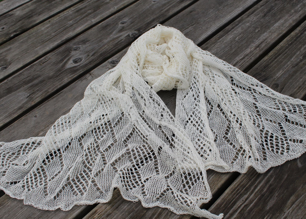 Knitted lace shawl on a wooden surface