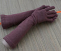 Pair of purple gloves on a textured surface