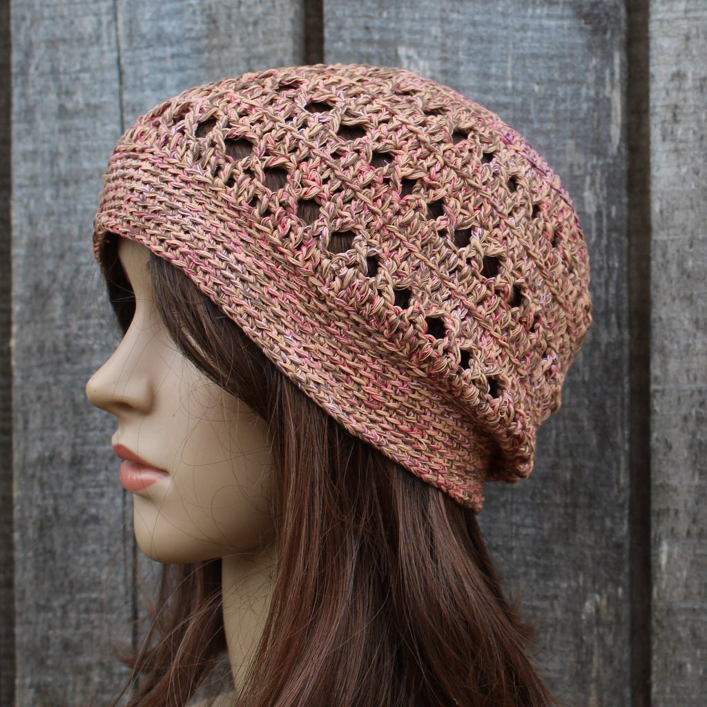 Knitted hat on a mannequin head against a wooden background