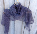 Purple lace shawl draped over a wooden surface