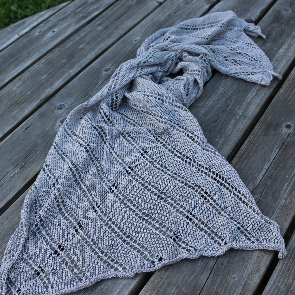 Knitted shawl on a wooden surface