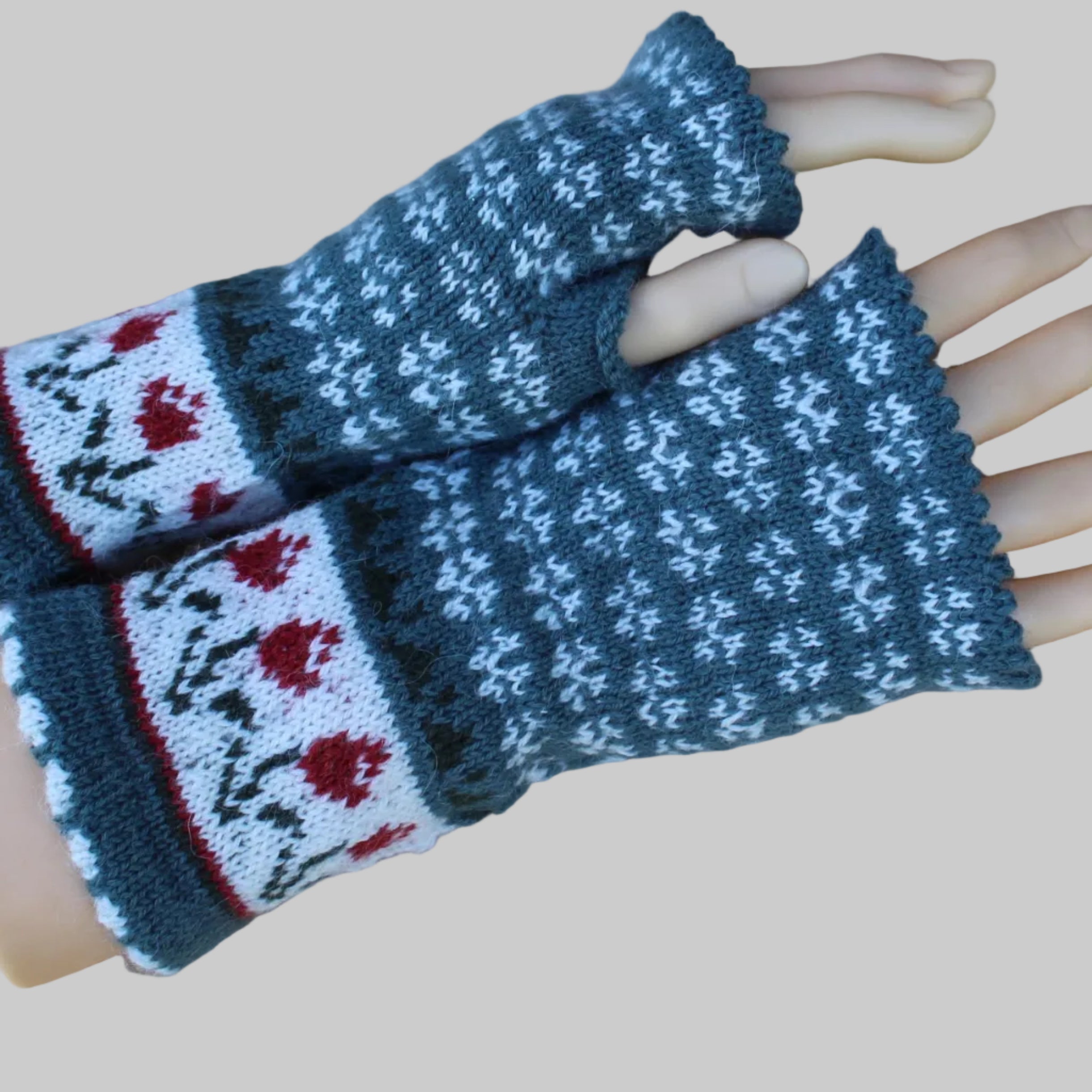 Pair of knitted fingerless gloves with a pattern on a mannequin hand.