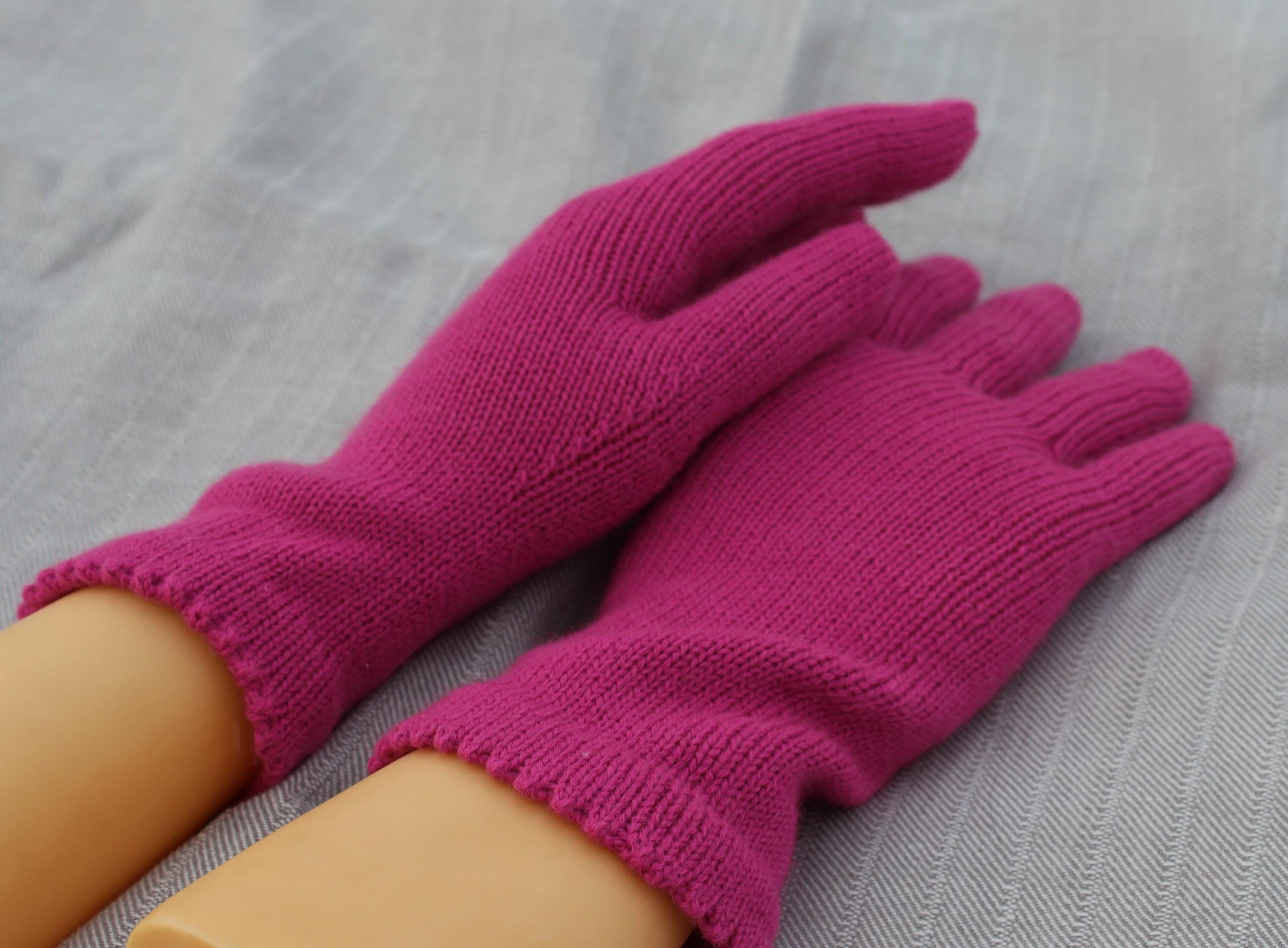 Purple gloves on a person's hands against a gray background