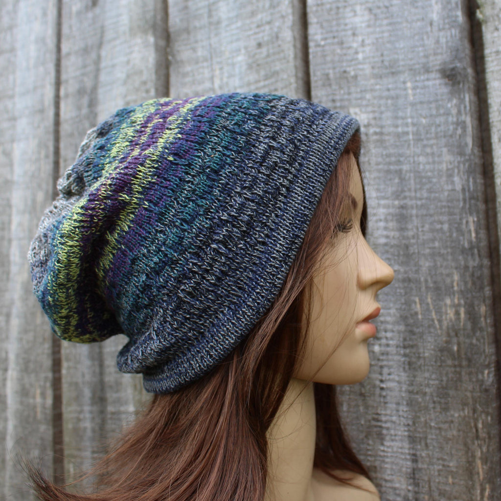 Knitted beanie on a mannequin head against a wooden background