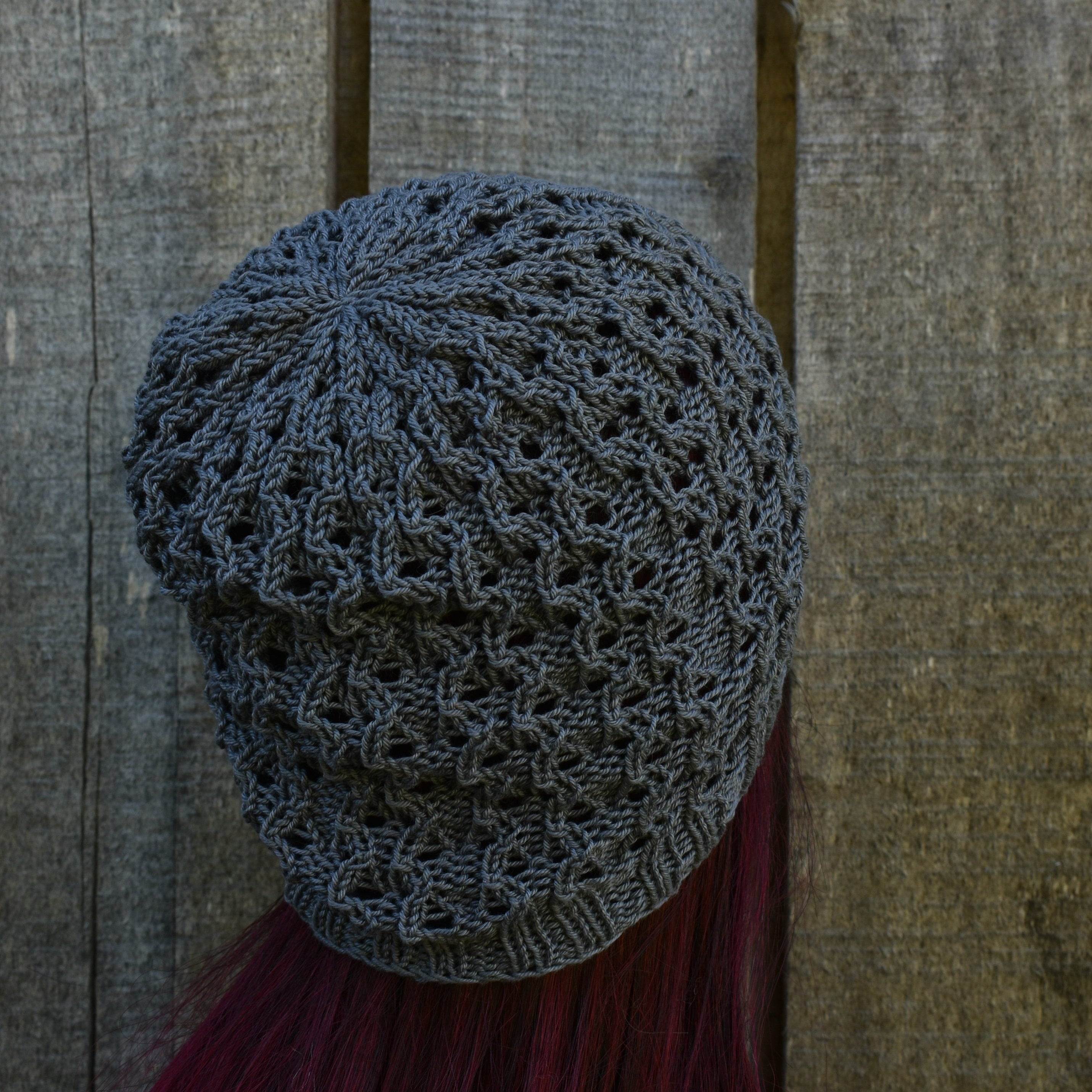 Knitted hat with a textured pattern on a wooden background