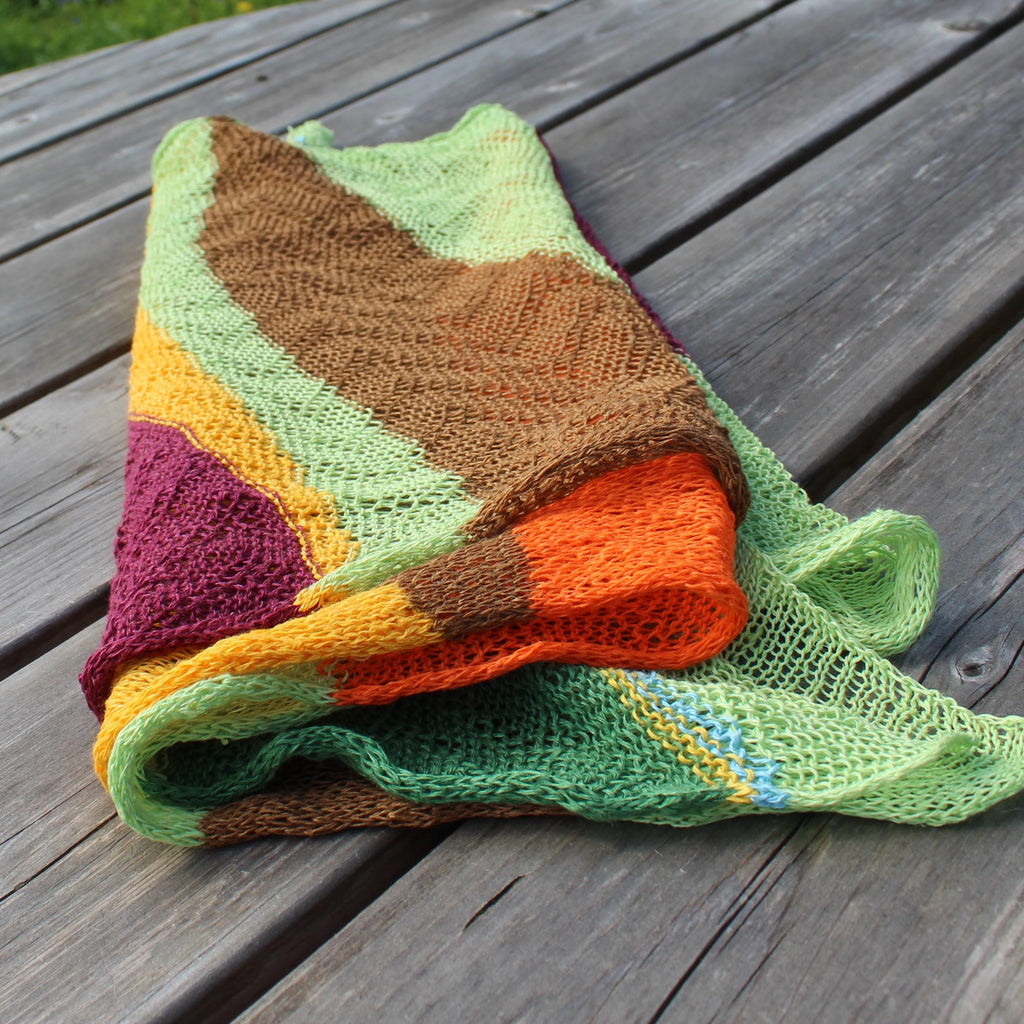 Colorful knitted blanket on a wooden surface