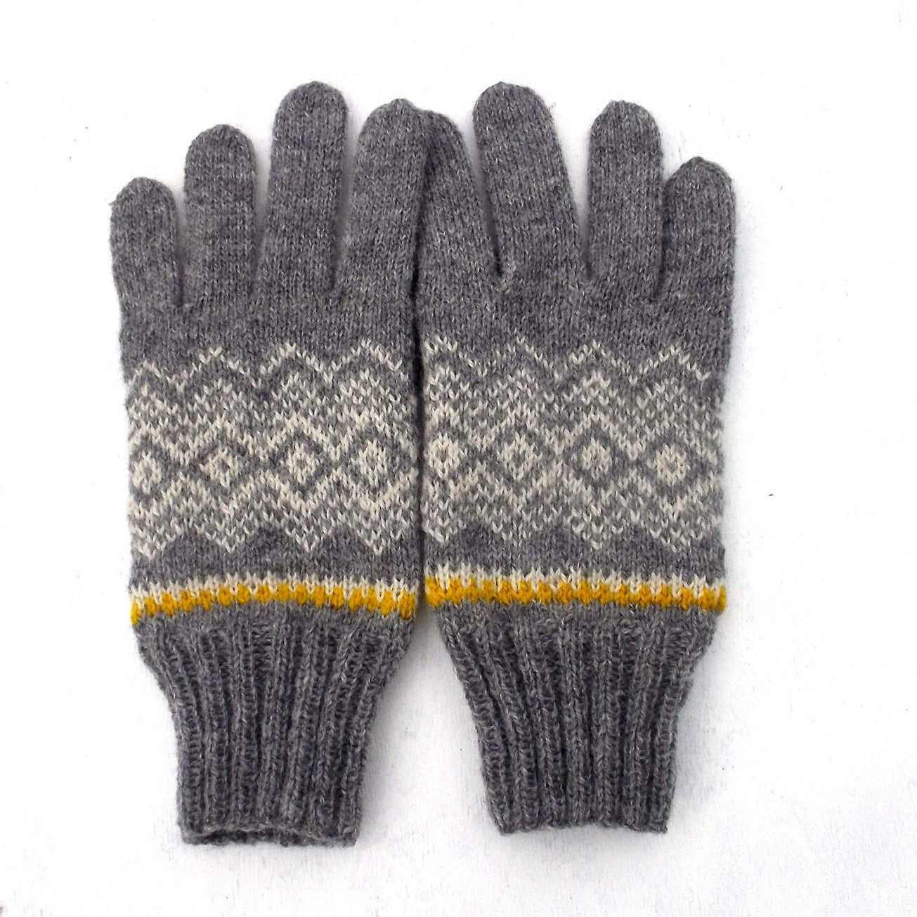 Pair of gray gloves with a patterned cuff on a white background