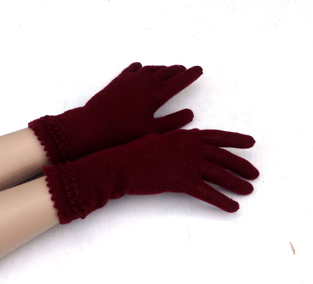 Pair of maroon gloves on a white background