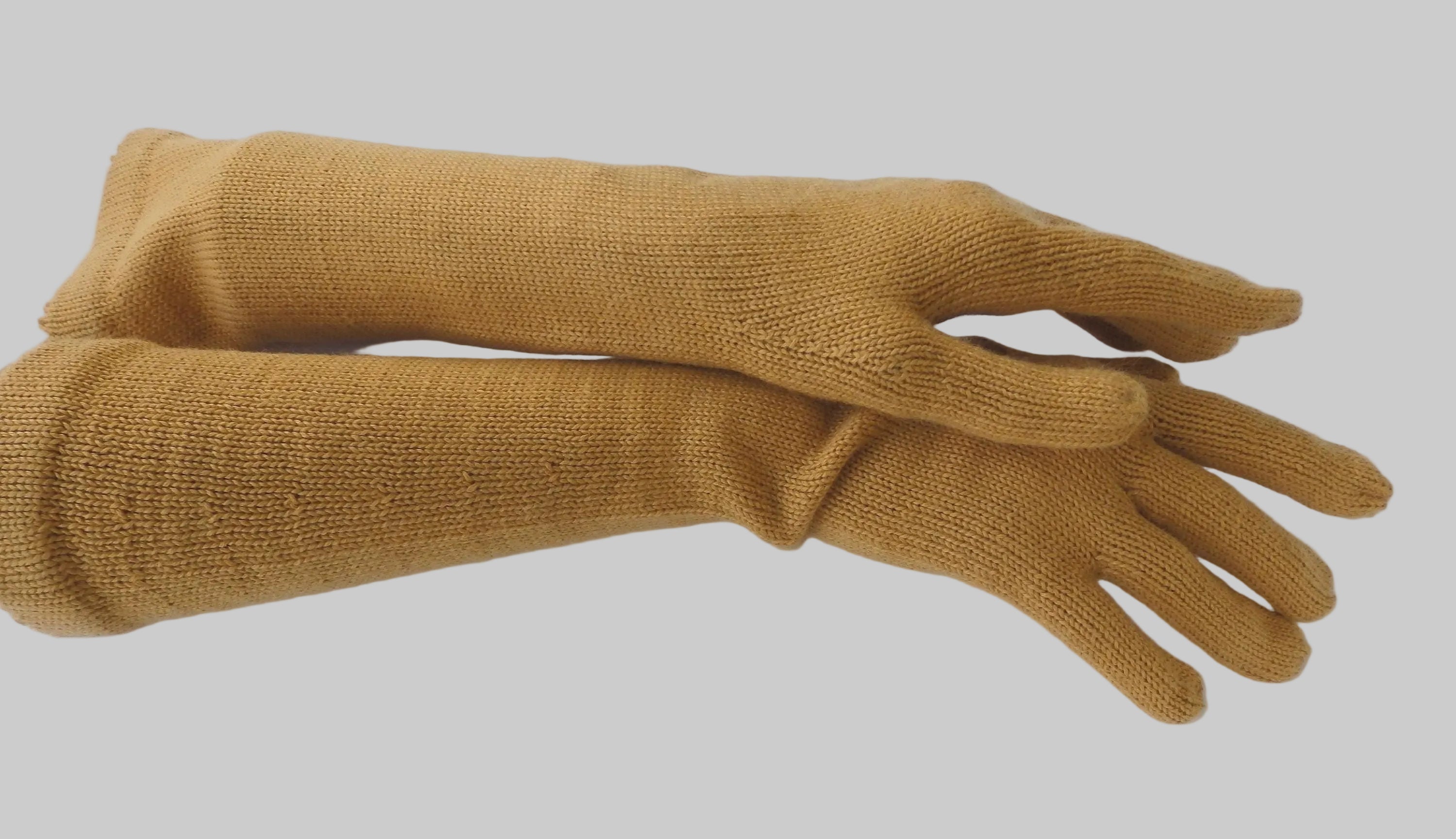Pair of mustard yellow gloves on a white background