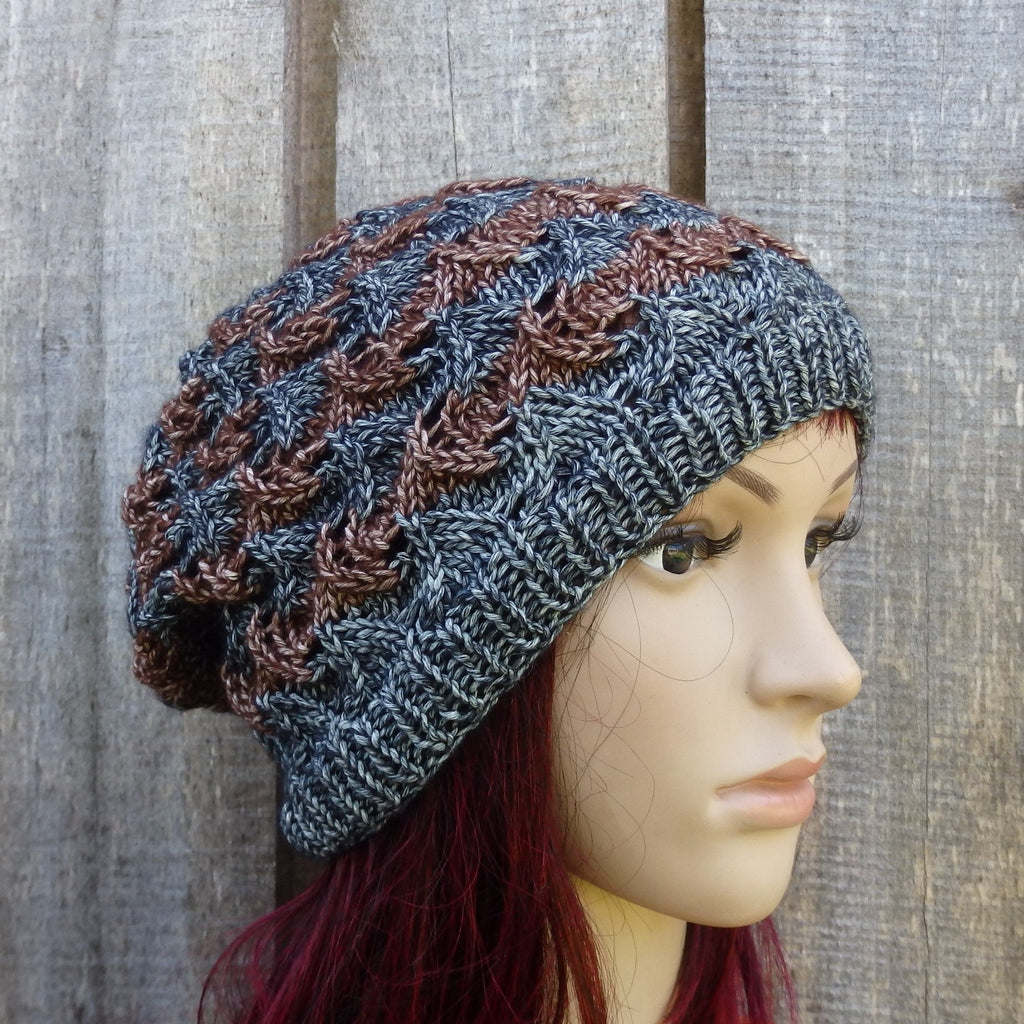 Knitted beanie on a mannequin head against a textured wall background
