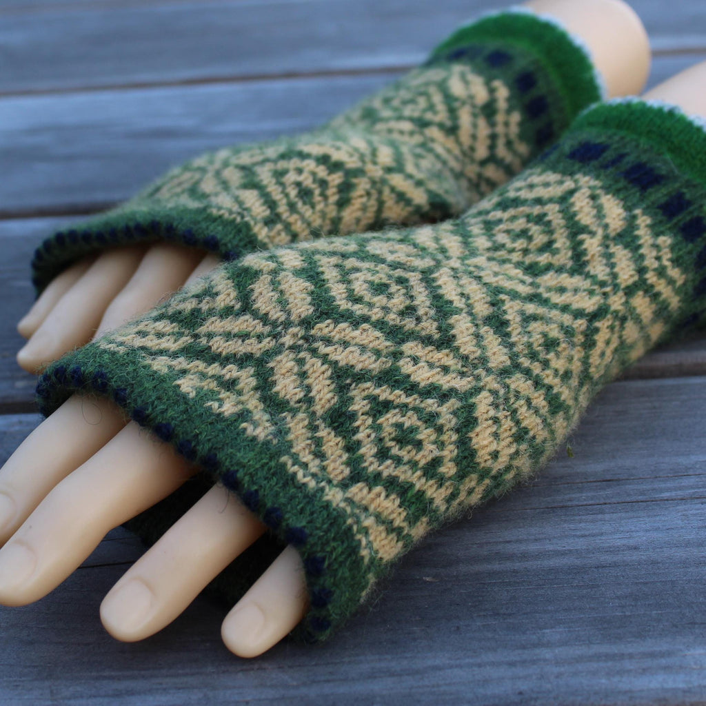 Green and  yellow  Latvian fingerless gloves on a wooden surface