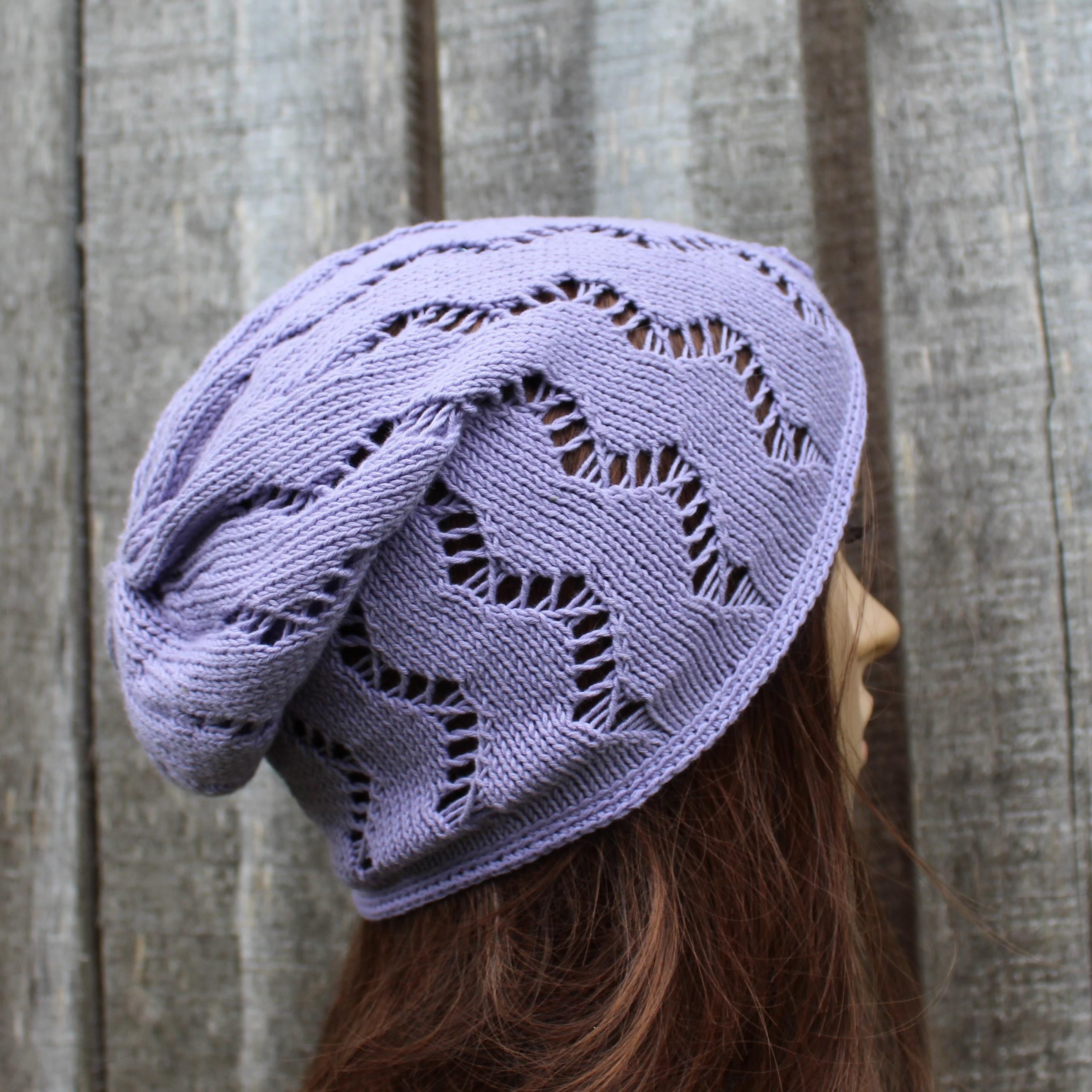 Lavender knitted beanie on a mannequin head against a wooden background