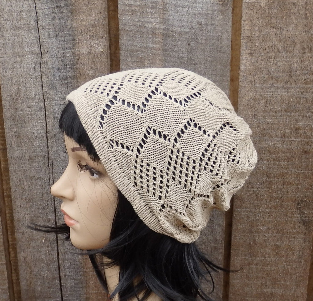 Beige knitted headscarf on a mannequin against a wooden background