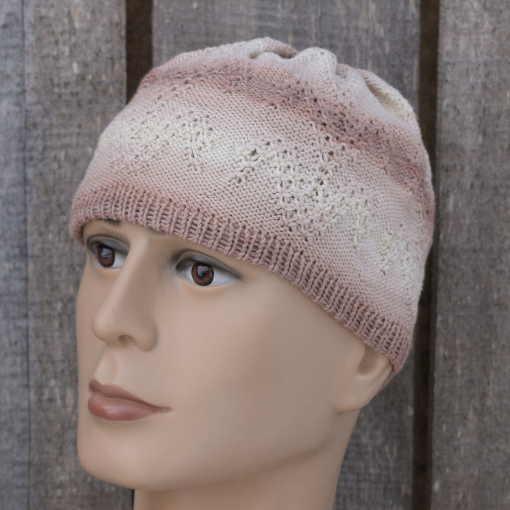 Knitted hat on a mannequin head against a wooden background
