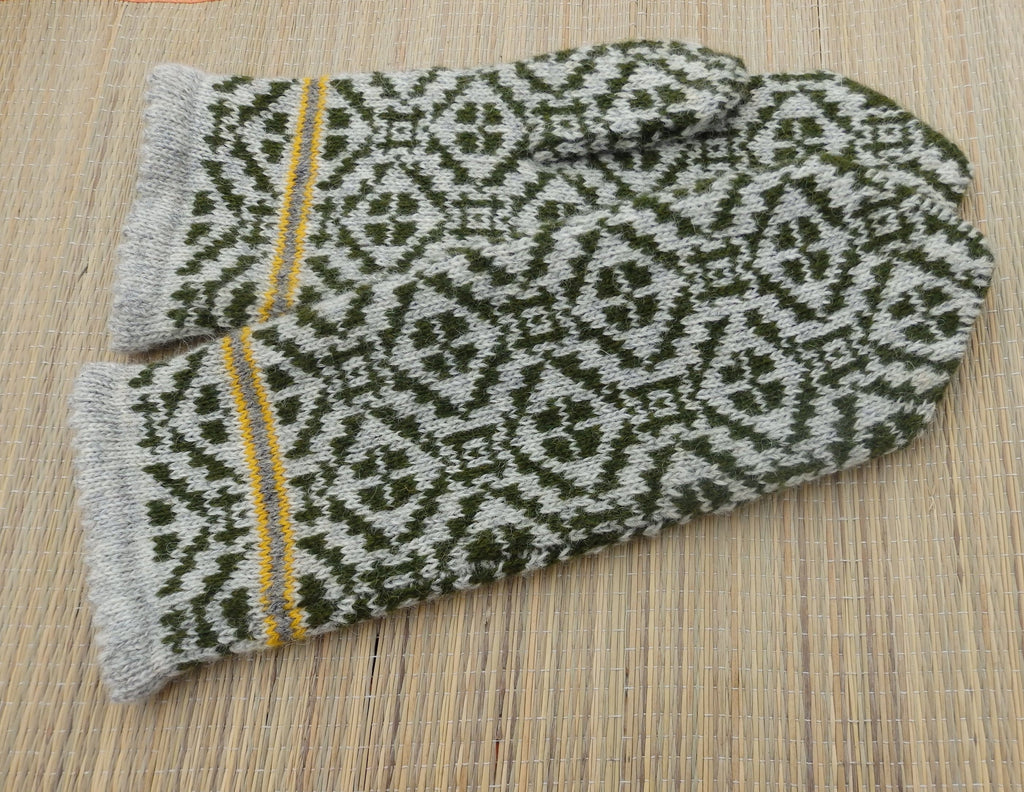 Pair of patterned gloves on a wooden surface