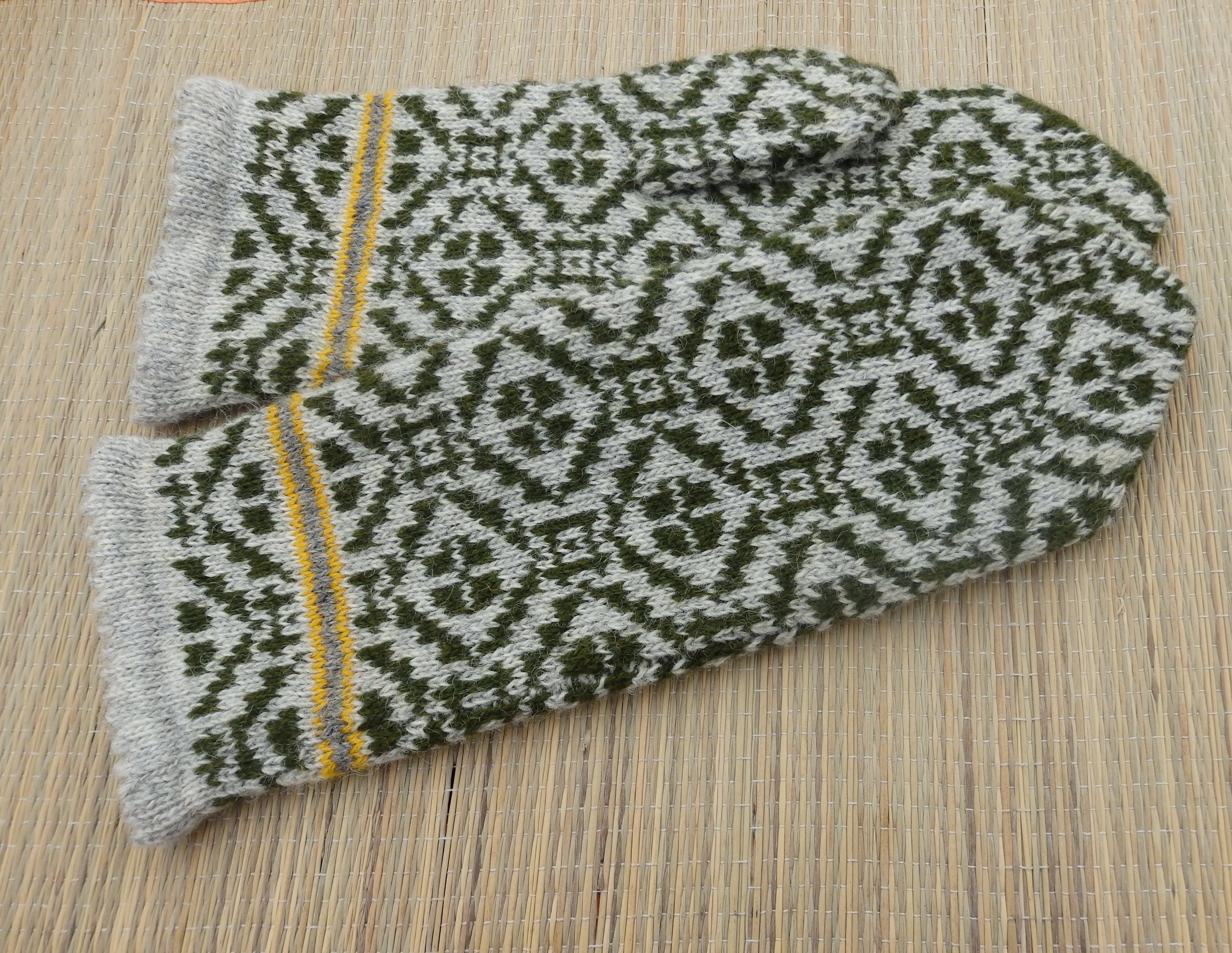 Pair of patterned gloves on a wooden surface