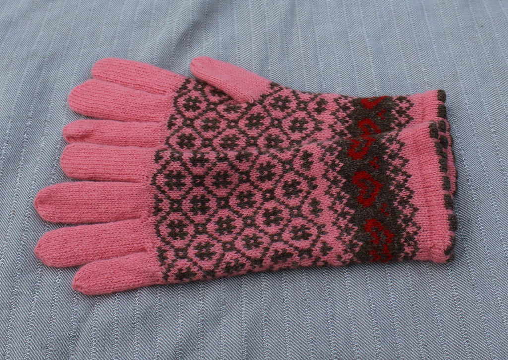 Pink and black patterned glove on a gray fabric background