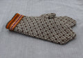 Knitted glove with a pattern on a textured surface