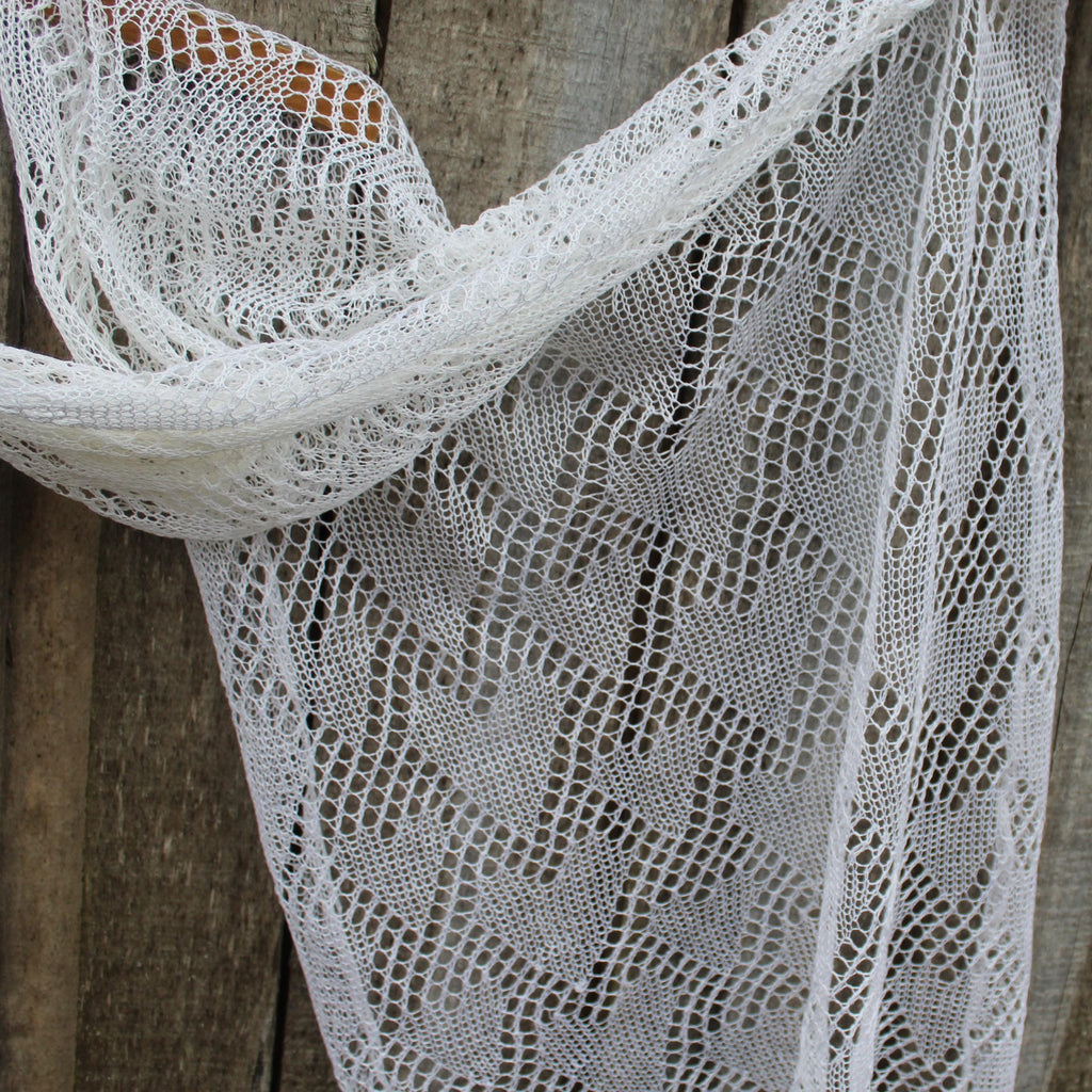 White lace scarf draped over a wooden surface