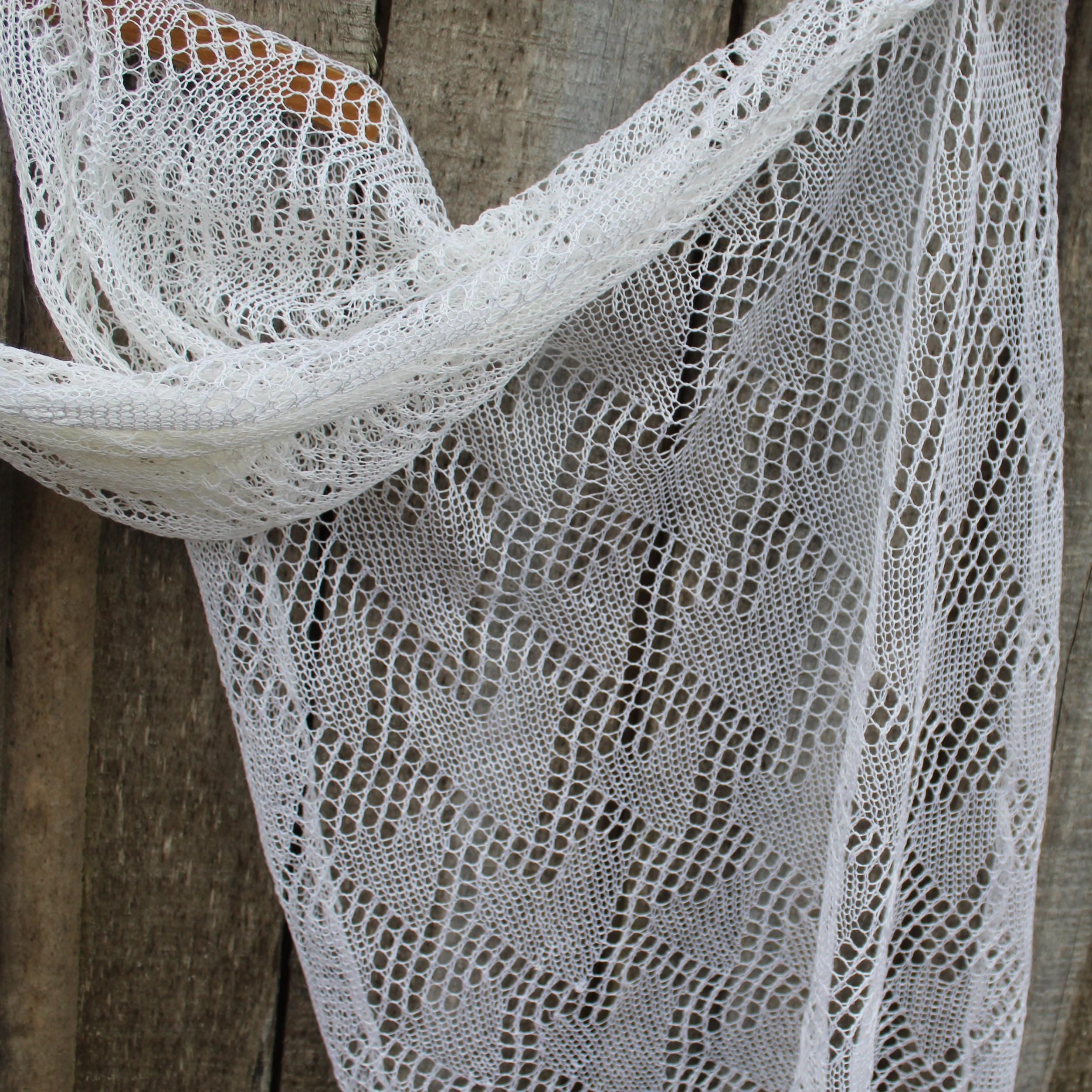 White lace scarf draped over a wooden surface