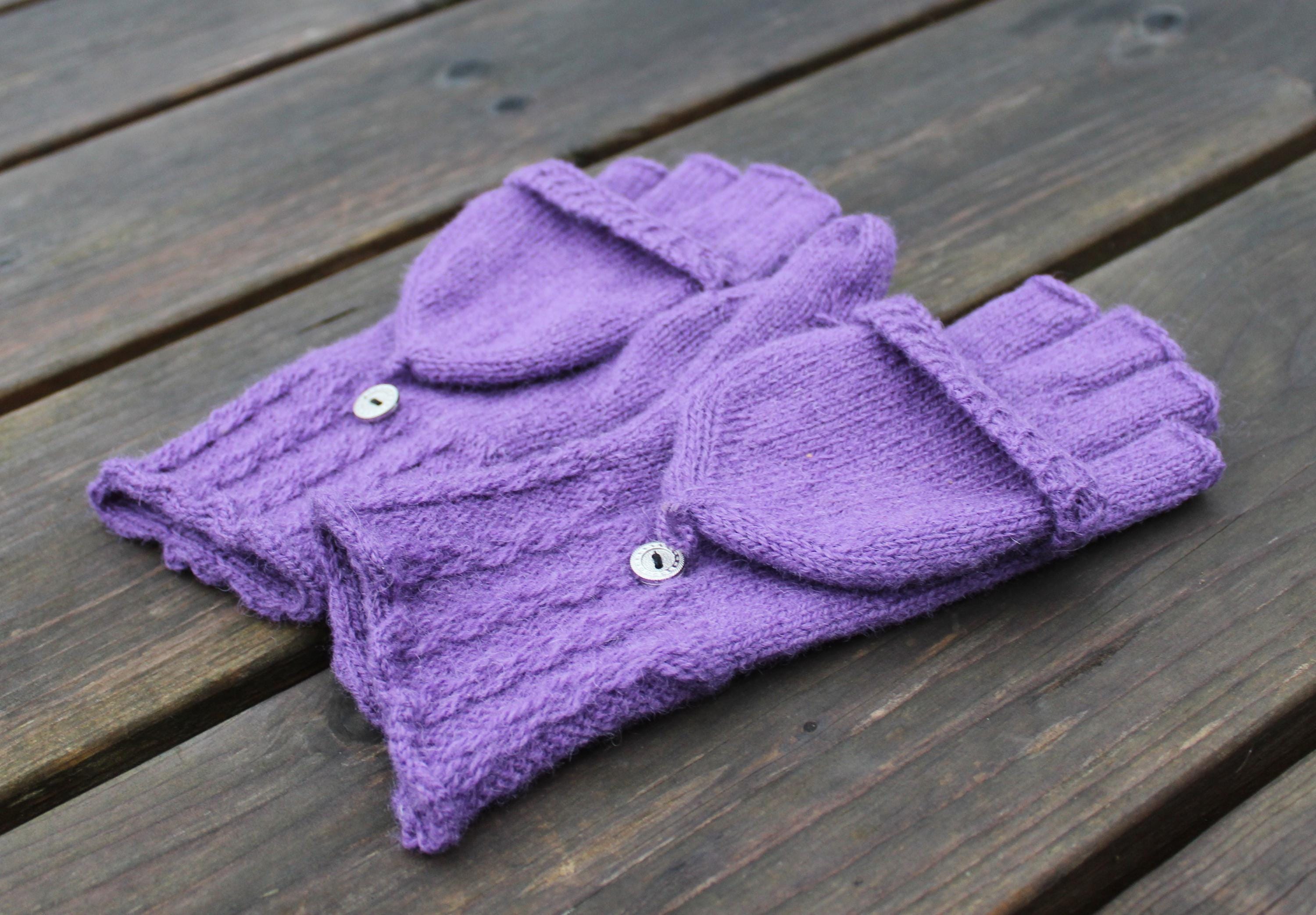 Purple knitted garment on a wooden surface