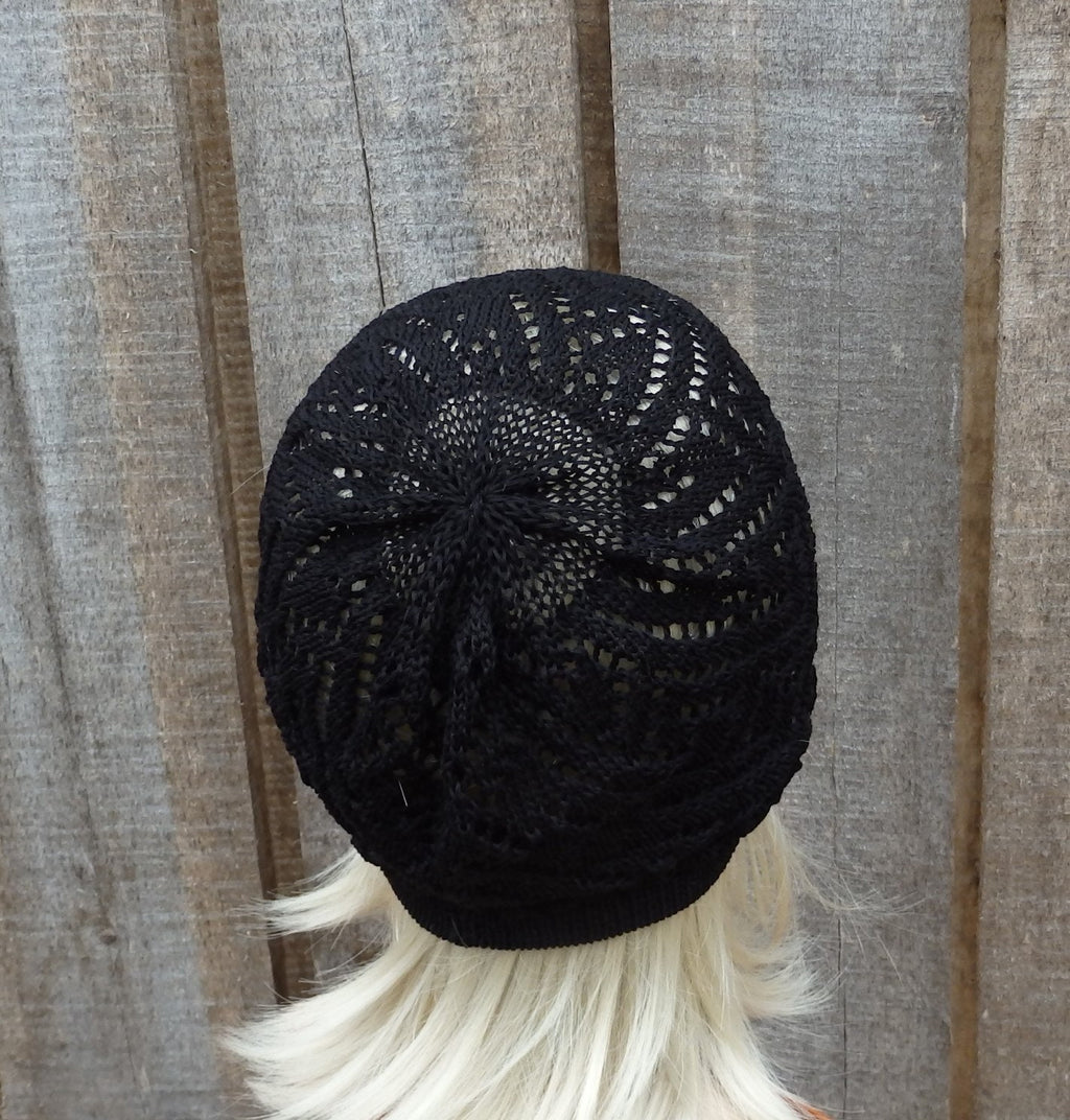 Black knitted beanie on a mannequin head against a wooden background