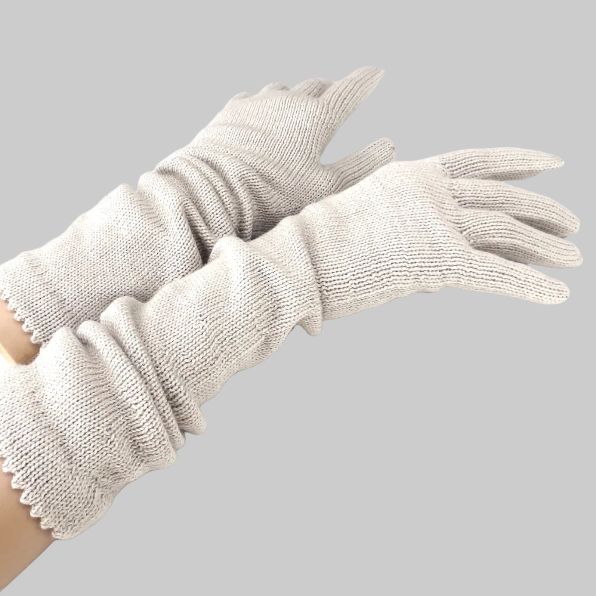 Pair of beige gloves on a white background