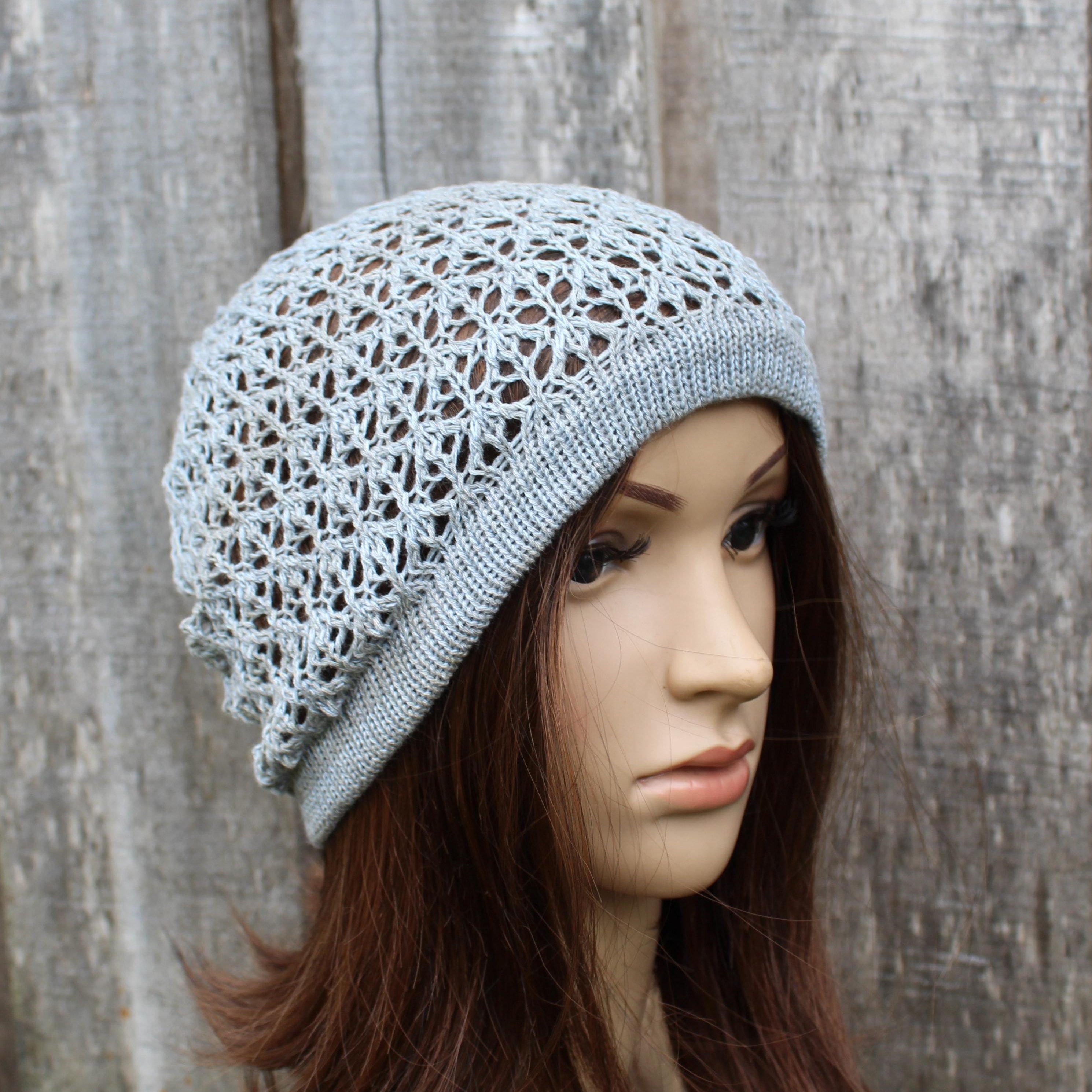 Light gray hat on a mannequin head against a wooden background