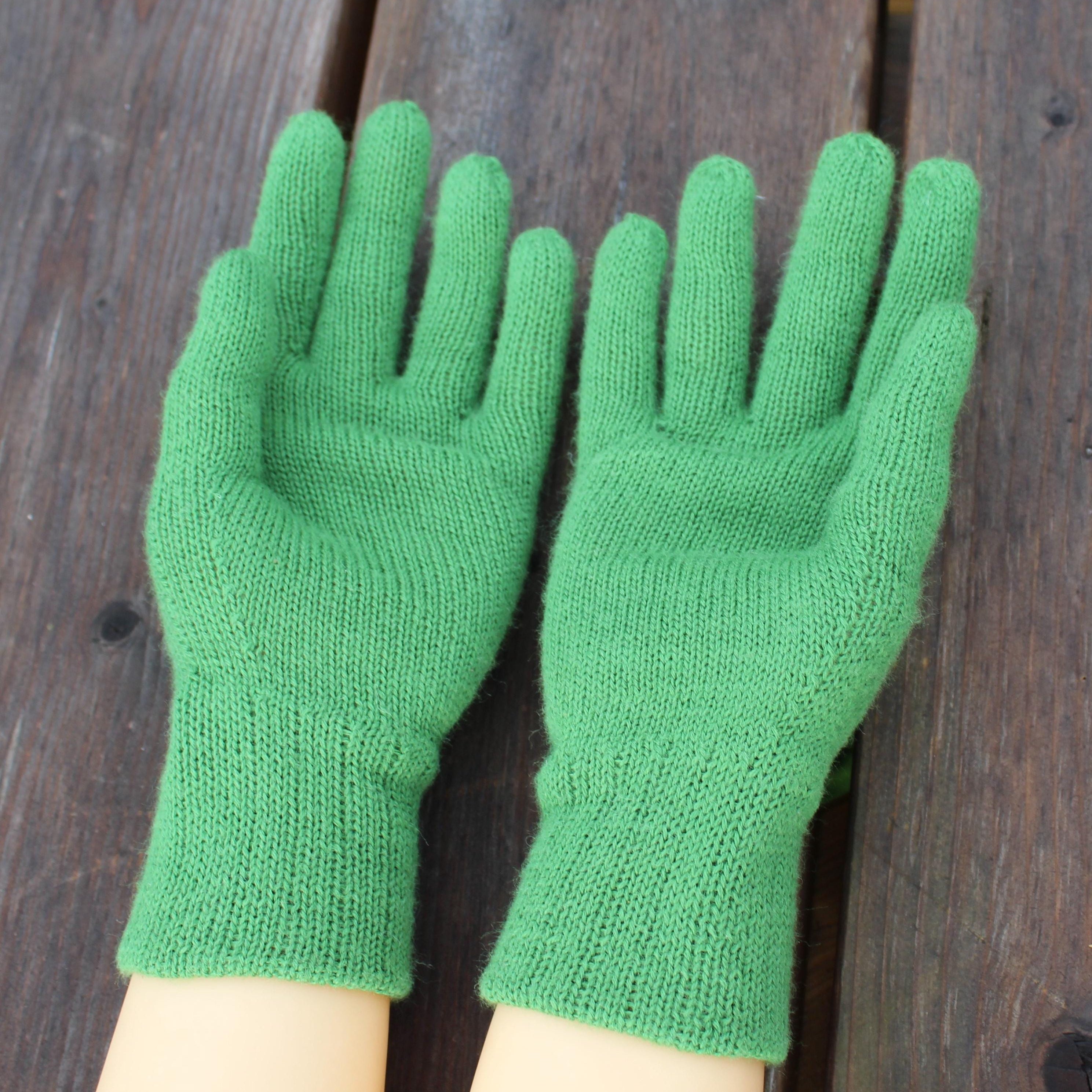 Green gloves on a wooden surface