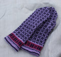 Pair of purple knitted mittens with a pattern on a light gray background