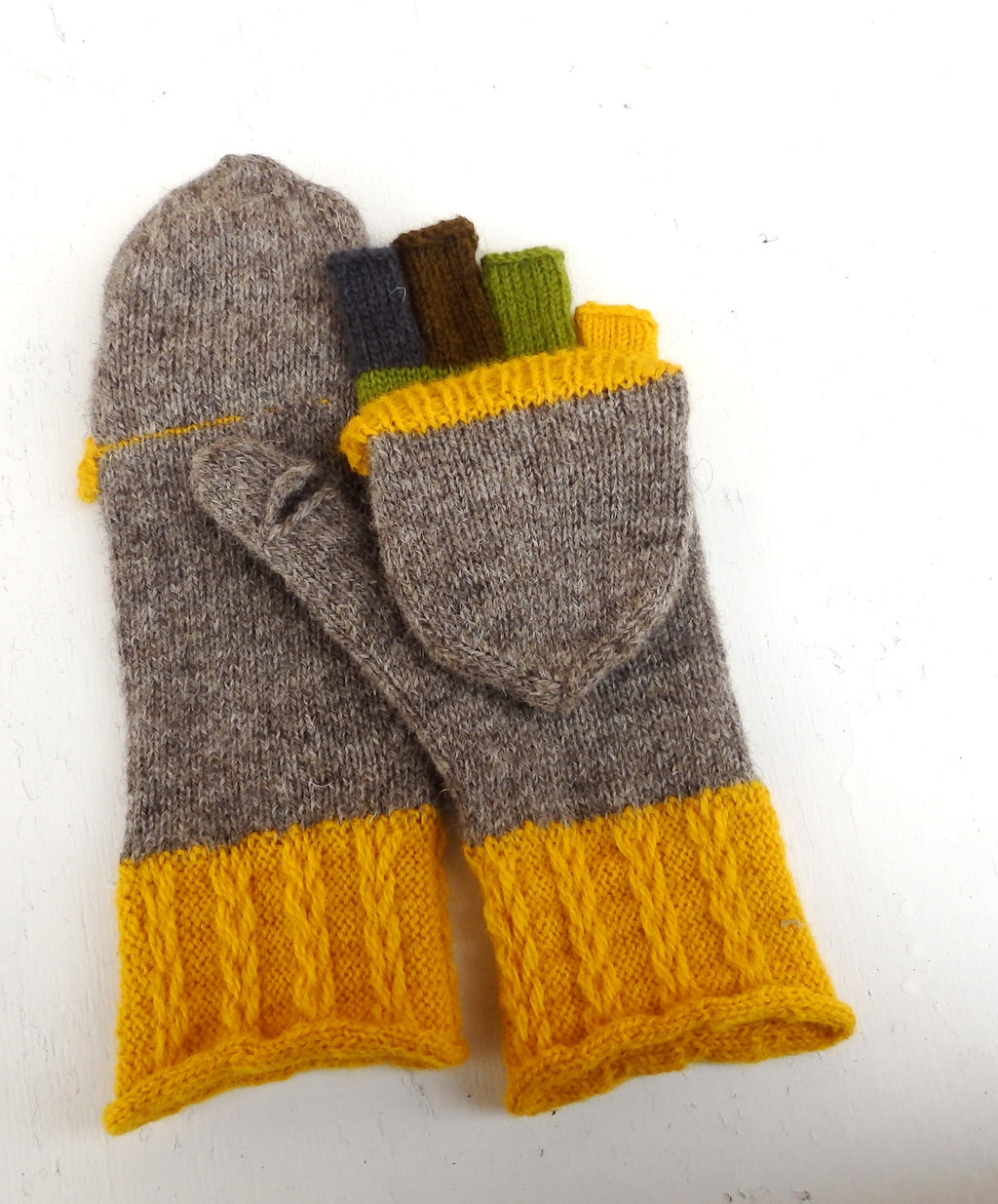 Pair of gray and yellow knit mittens on a white background