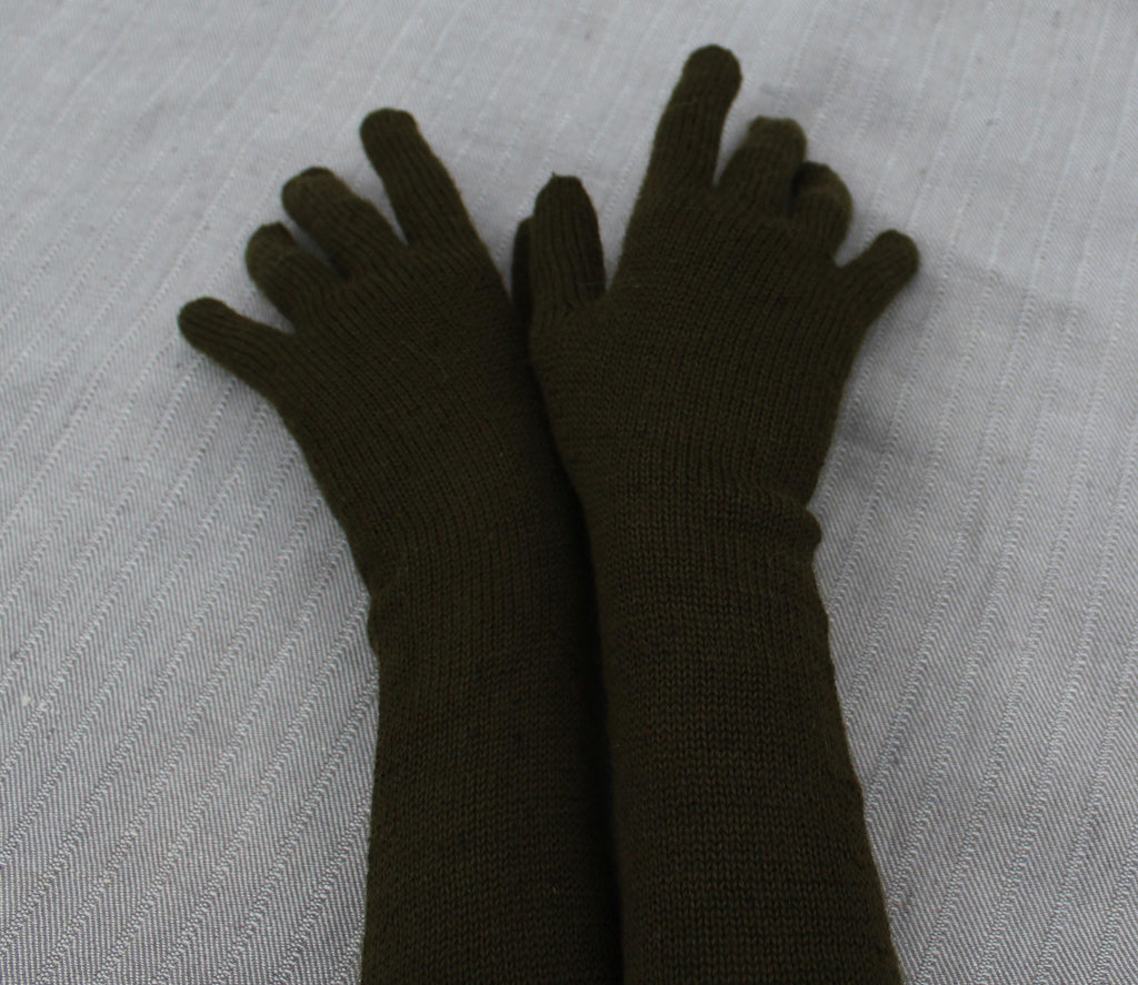 Pair of dark green gloves on a light gray textured surface