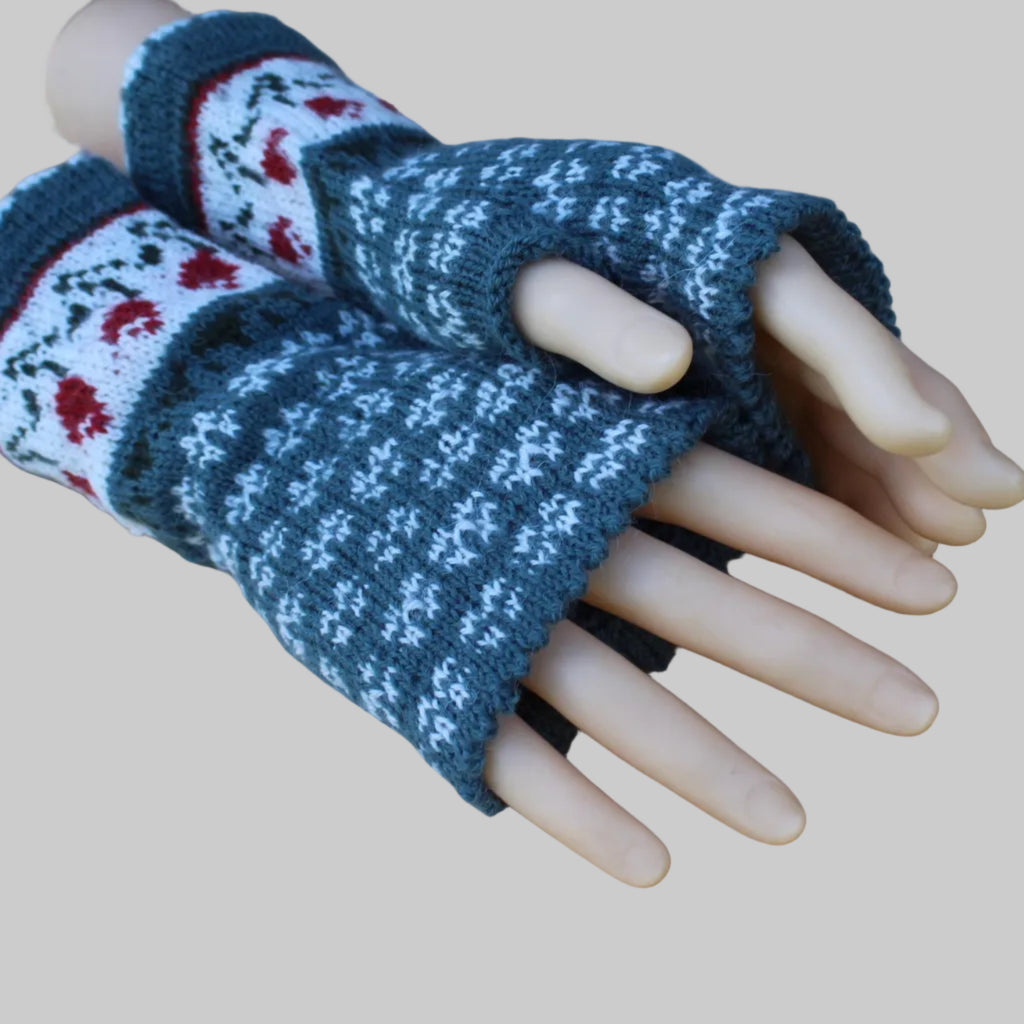 Pair of blue and white patterned fingerless gloves on a mannequin hand against a wooden background