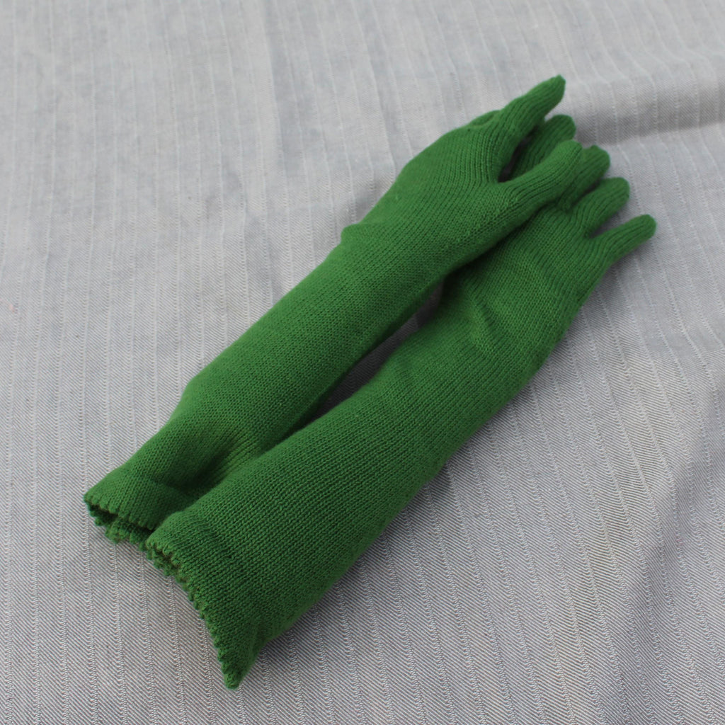 Pair of green gloves on a gray textured background