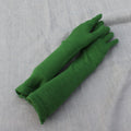 Pair of green gloves on a gray textured background