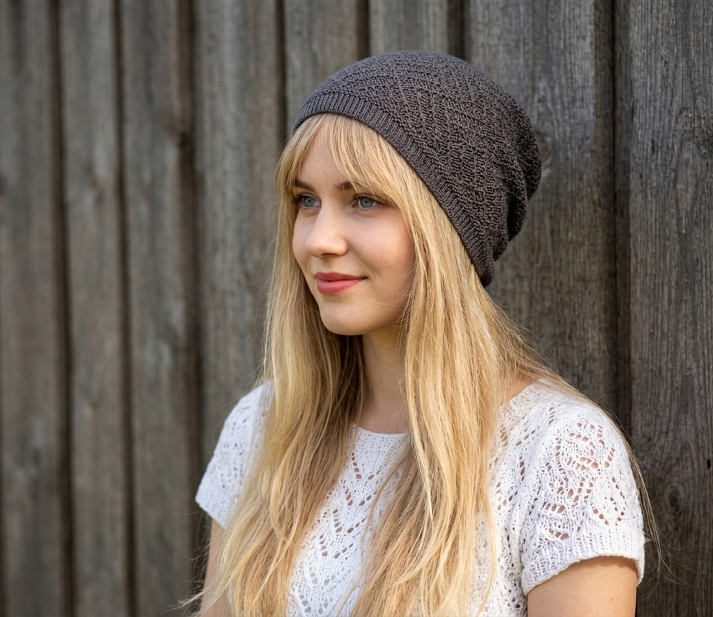 Woman wearing a brown knit beanie against a wooden background