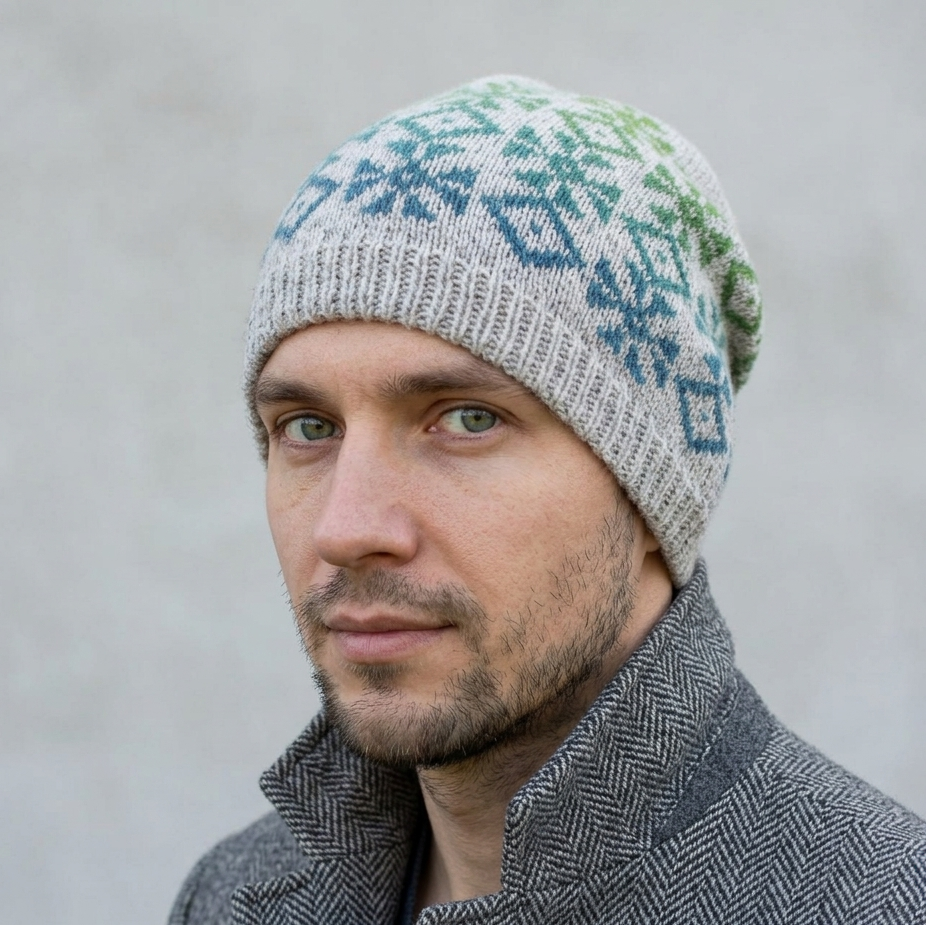 Man wearing a patterned knit hat against a plain background