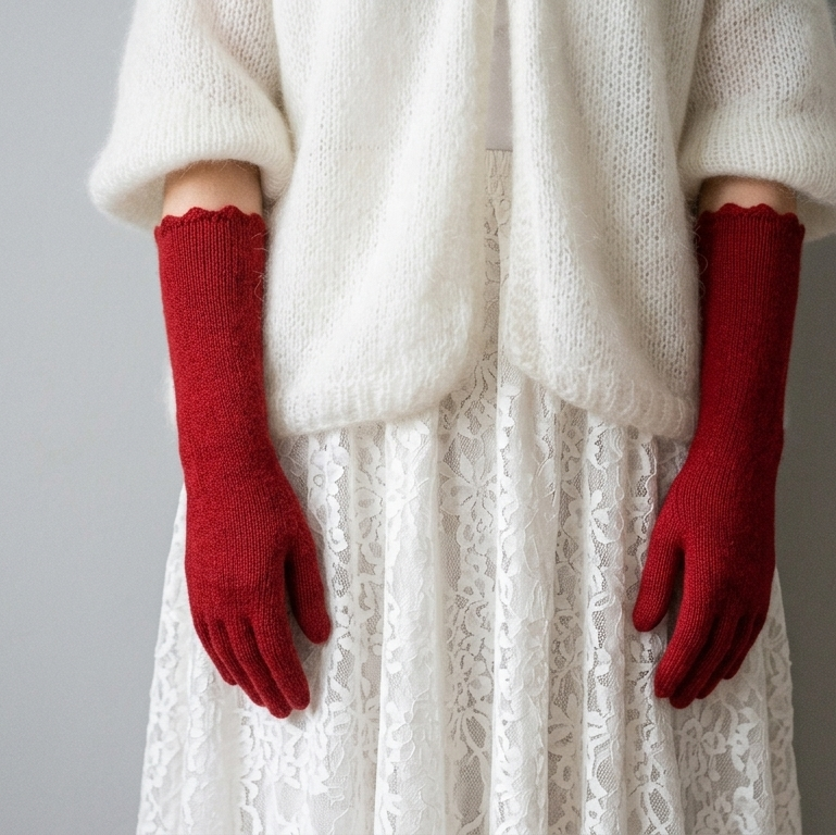 Person wearing a white outfit and red gloves on a gray background