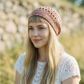 Woman wearing a  knitted hat in an outdoor setting
