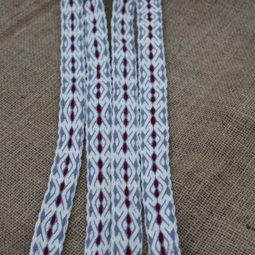Woven belt with a geometric pattern on a textured fabric background
