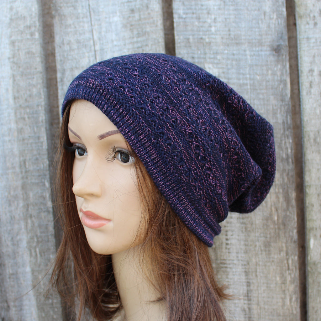 Mannequin head wearing a lue knit beanie against a wooden background