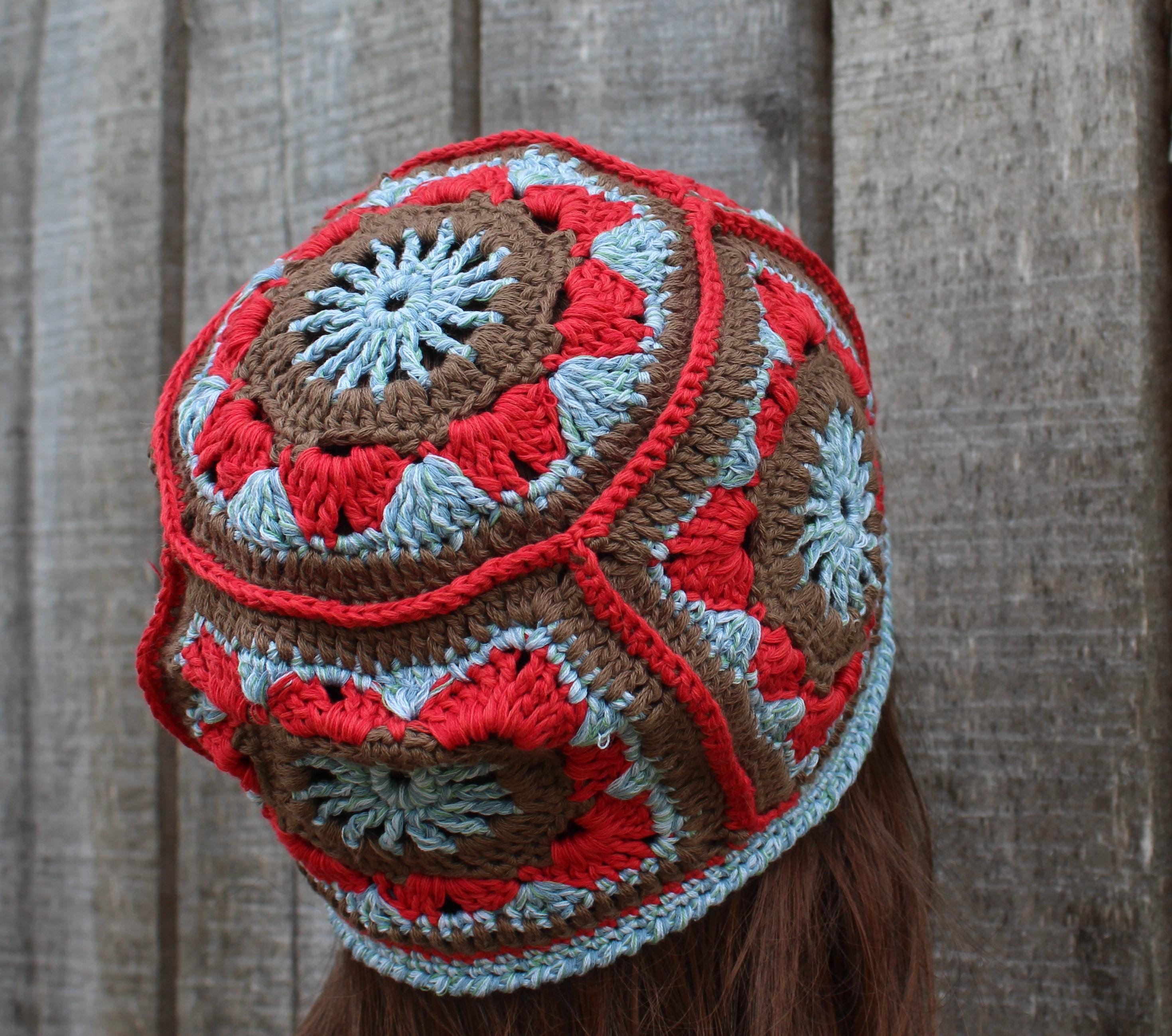 Colorful crocheted hat with intricate patterns against a wooden background